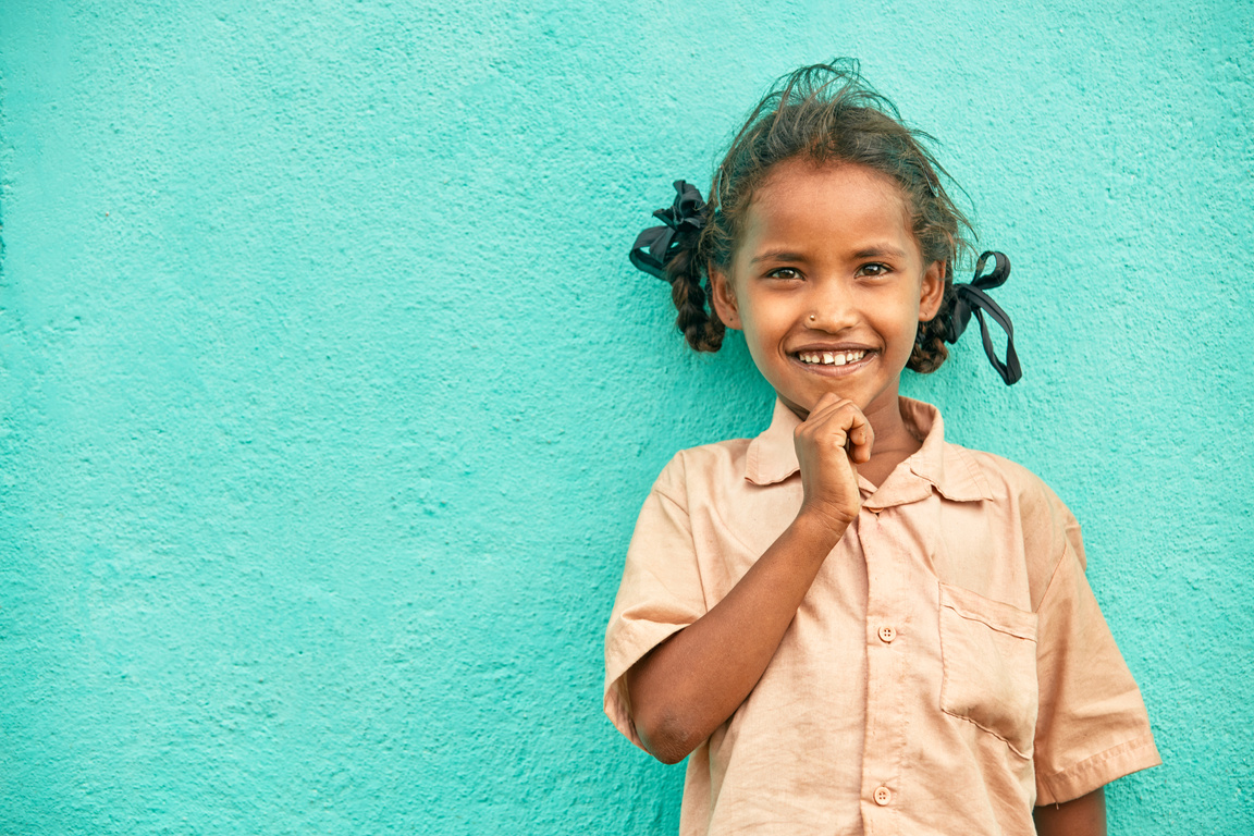 Happy cute poor Indian little girl portrait